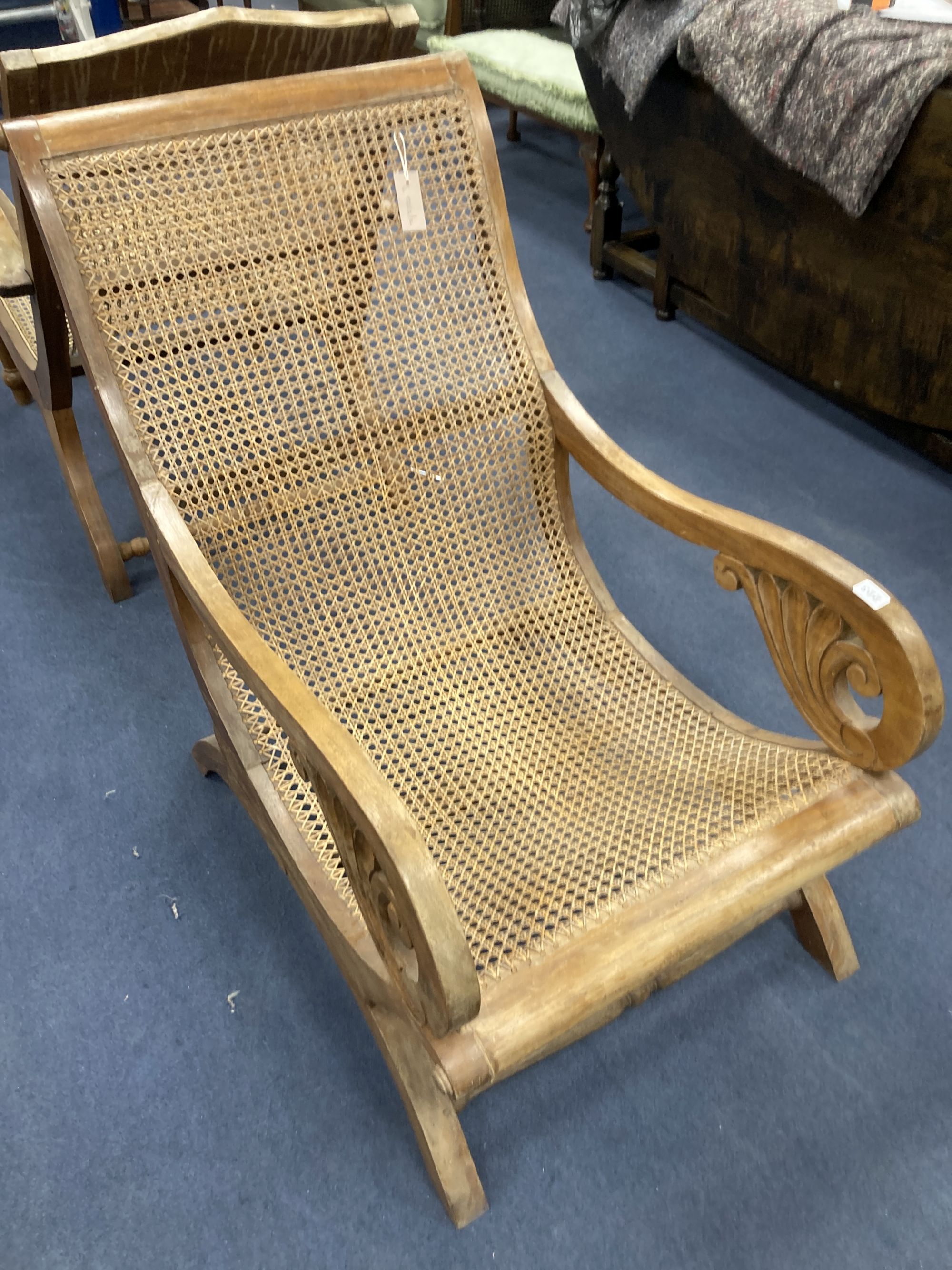 An early 20th century Anglo-Indian caned weathered teak armchair, width 57cm, depth 90cm, height 85cm